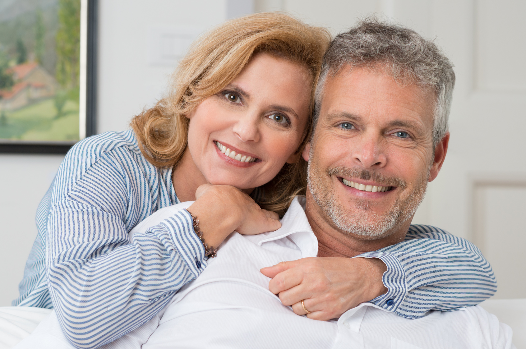 Portrait Of A Mature Couple Smiling And Embracing At Home